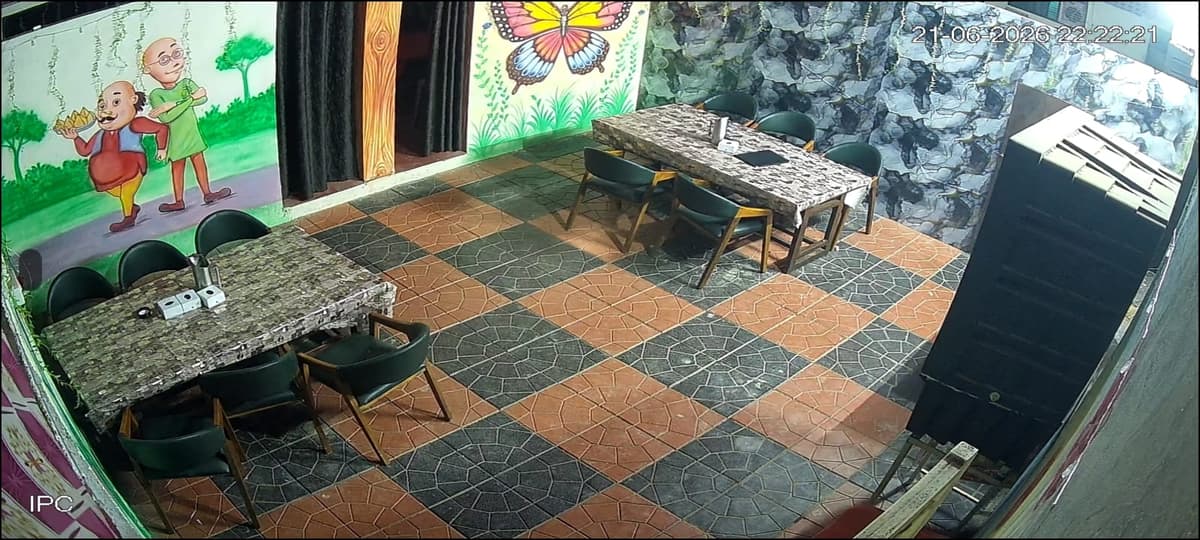 Themed dining area with cartoon wall art and butterfly mural